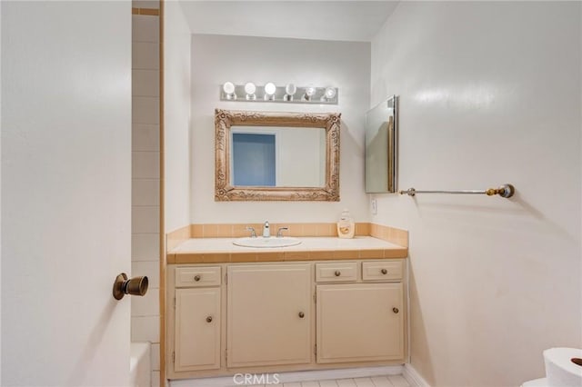 bathroom featuring vanity and a washtub