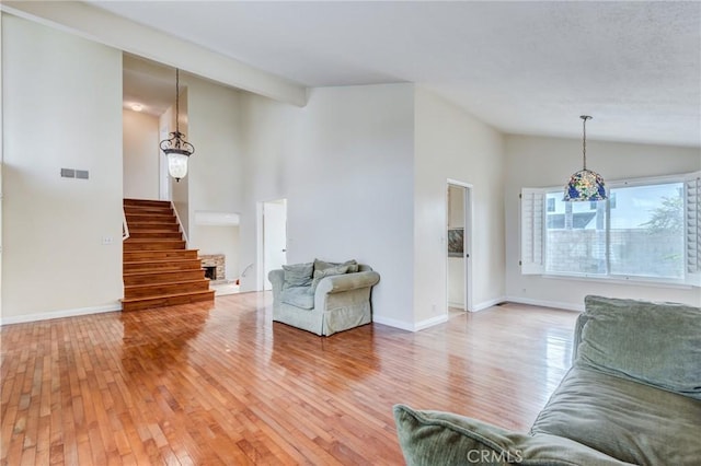 unfurnished living room with hardwood / wood-style flooring and lofted ceiling with beams