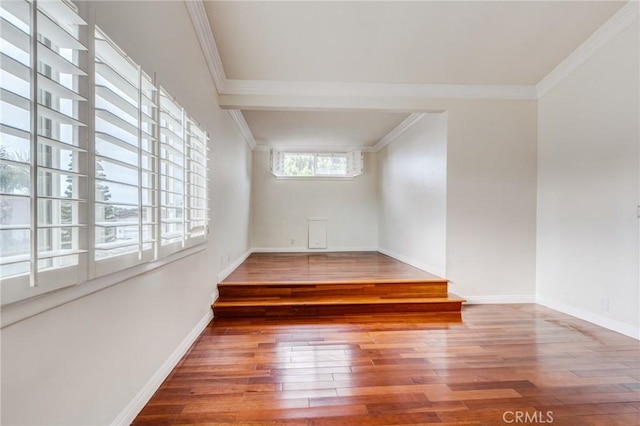 spare room with ornamental molding and hardwood / wood-style floors