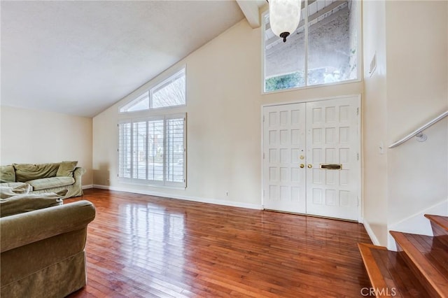 foyer featuring hardwood / wood-style flooring and high vaulted ceiling