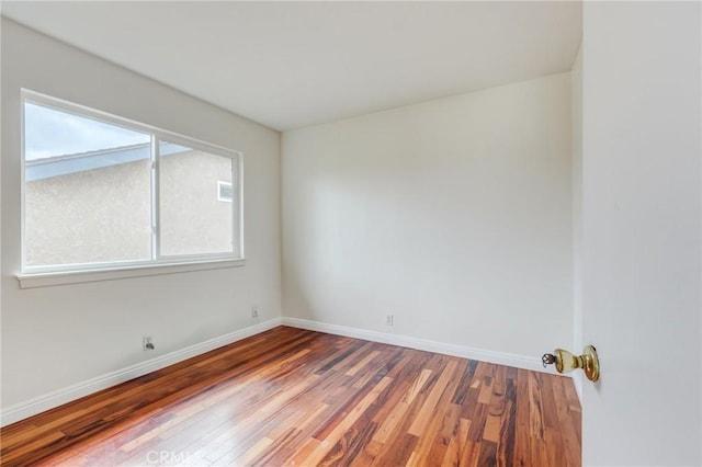 spare room with hardwood / wood-style flooring