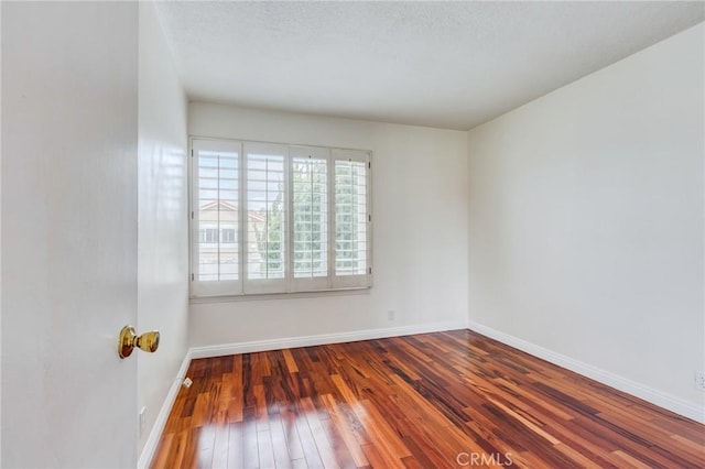 unfurnished room featuring dark wood-type flooring