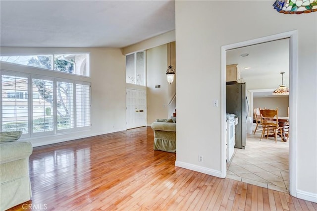 living room featuring hardwood / wood-style flooring and high vaulted ceiling