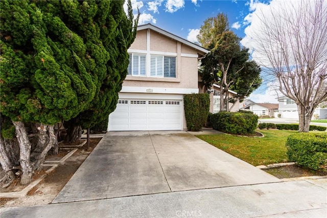 view of front of property with a garage and a front yard