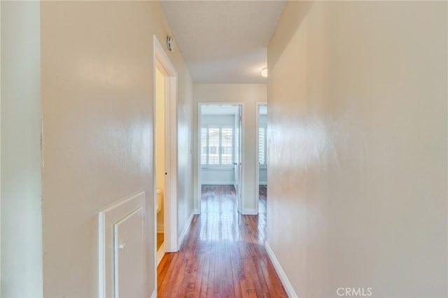 corridor featuring wood-type flooring