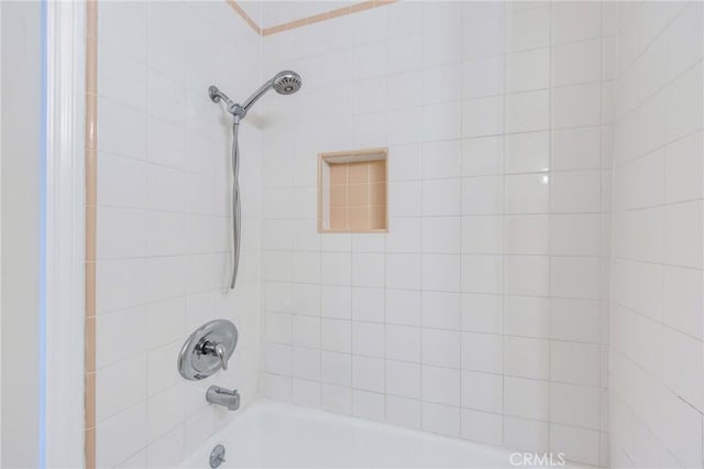 bathroom featuring tiled shower / bath