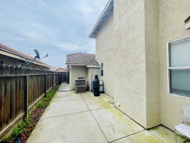 view of home's exterior featuring central AC and a patio