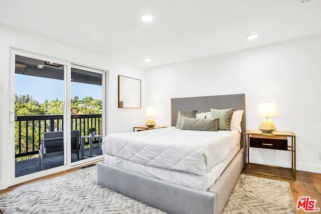 bedroom with light hardwood / wood-style flooring and access to outside