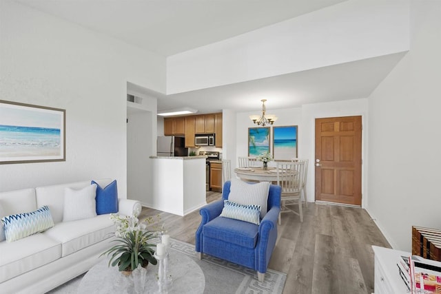 living room featuring light hardwood / wood-style floors and a notable chandelier