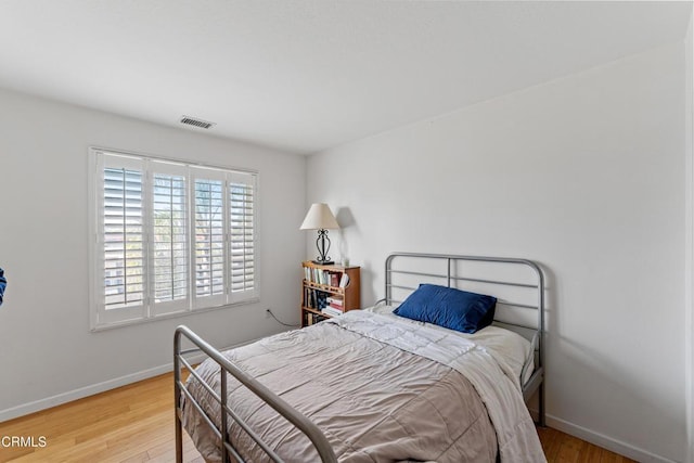 bedroom with hardwood / wood-style flooring