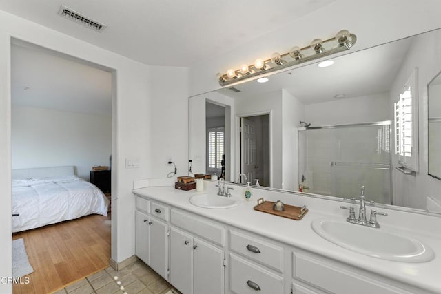 bathroom featuring tile patterned floors, vanity, and an enclosed shower