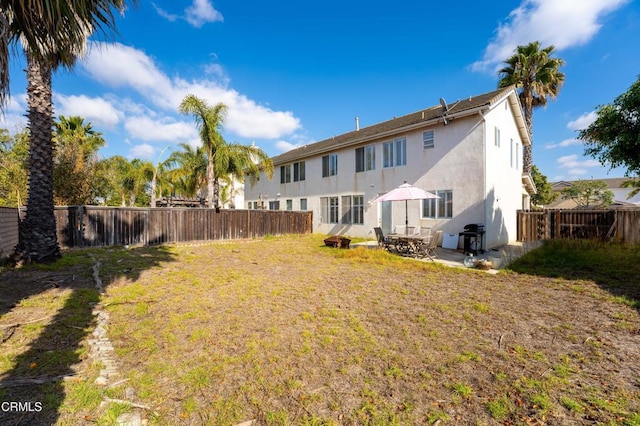 rear view of property featuring a patio area