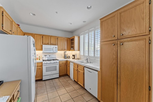 kitchen with sink, decorative backsplash, light tile patterned floors, tile counters, and white appliances