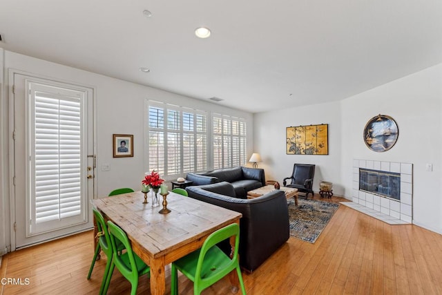 living room with light hardwood / wood-style flooring and a fireplace