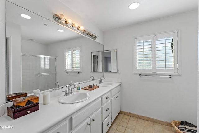 bathroom featuring vanity and a shower with shower door