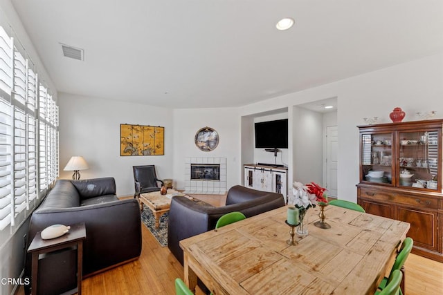 dining area featuring a fireplace and light hardwood / wood-style floors