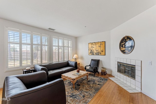 living room featuring a fireplace and light hardwood / wood-style floors