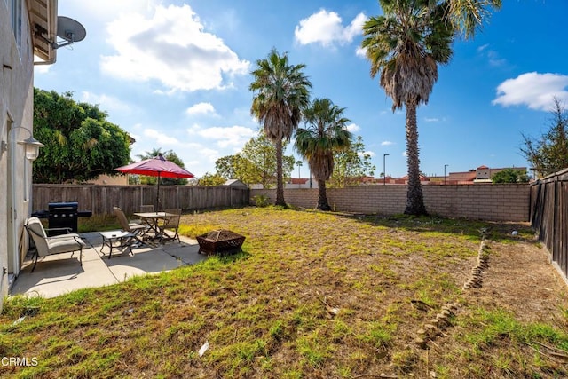 view of yard with a patio area and a fire pit