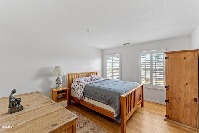 bedroom with light hardwood / wood-style floors