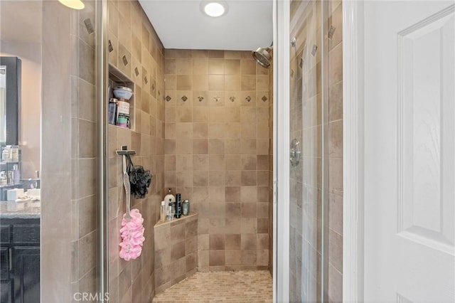 bathroom featuring vanity and tiled shower