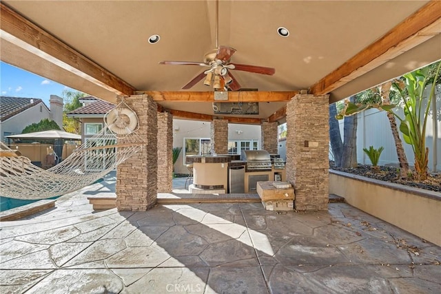 view of patio / terrace featuring ceiling fan, a grill, and exterior kitchen