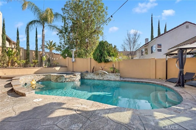 view of pool with a patio area and an in ground hot tub