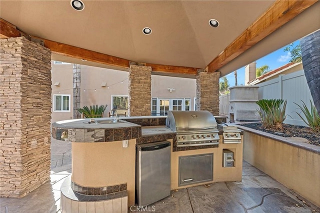 view of patio with an outdoor kitchen and area for grilling