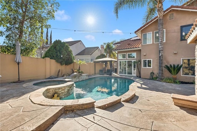 view of pool featuring a patio and an in ground hot tub