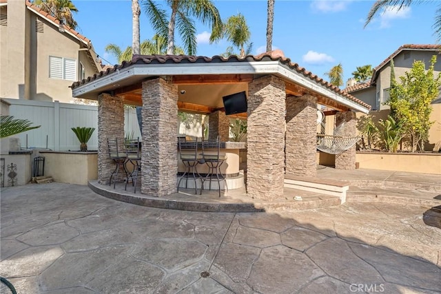 view of patio with a gazebo and an outdoor bar