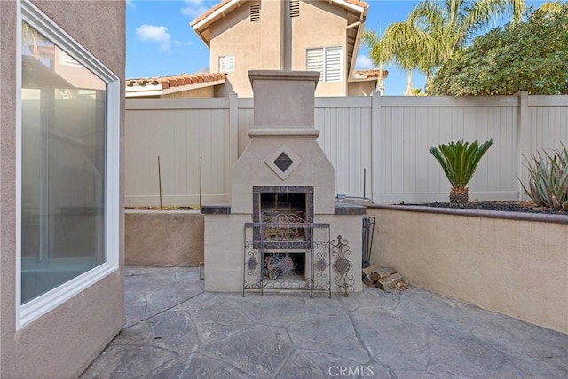 view of patio featuring exterior fireplace