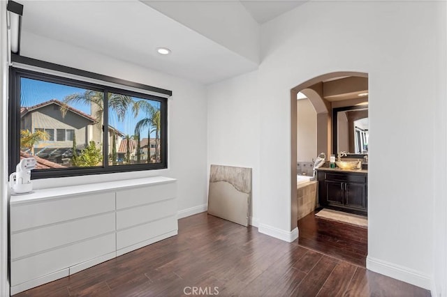 interior space featuring ensuite bath and dark hardwood / wood-style flooring