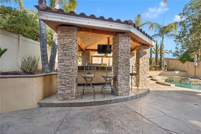 view of patio featuring exterior bar and area for grilling