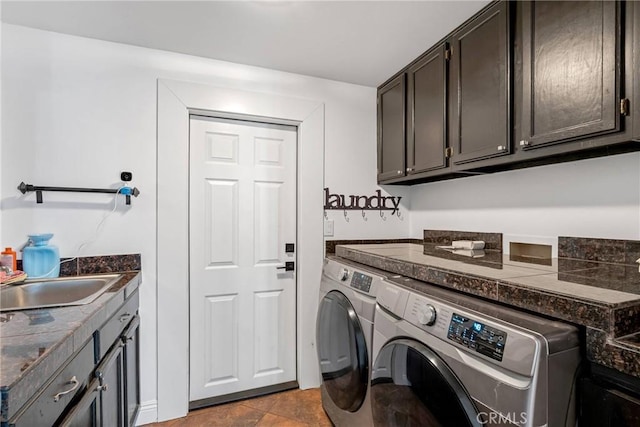 clothes washing area featuring cabinets, independent washer and dryer, and sink