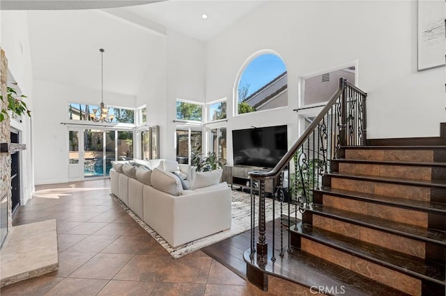 tiled living room with an inviting chandelier and a high ceiling