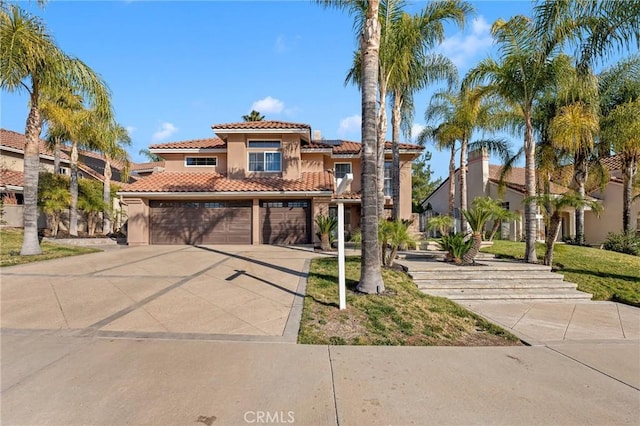 mediterranean / spanish-style home featuring a garage