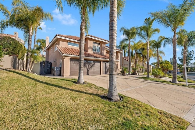 mediterranean / spanish-style house featuring a garage and a front lawn