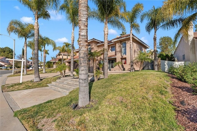 mediterranean / spanish-style house featuring a front lawn