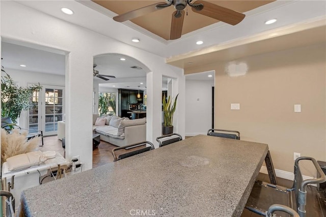 kitchen with a kitchen breakfast bar and ceiling fan