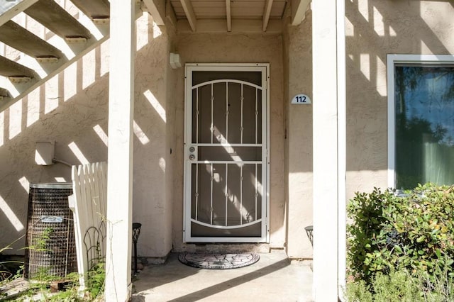 doorway to property with stucco siding