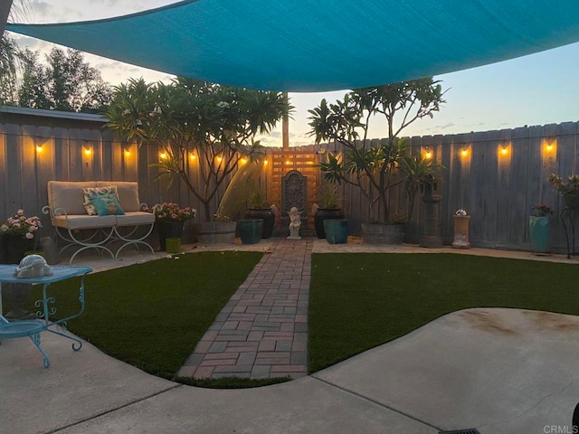 view of yard with a patio area, a fenced backyard, and an outdoor living space