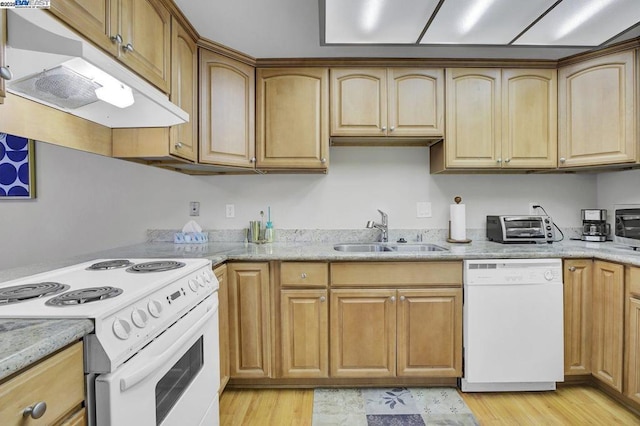 kitchen with white appliances, light hardwood / wood-style floors, sink, and light stone countertops