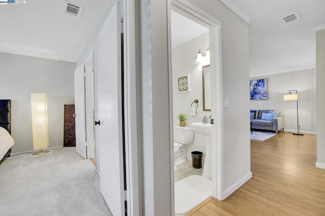 bathroom with hardwood / wood-style floors and toilet