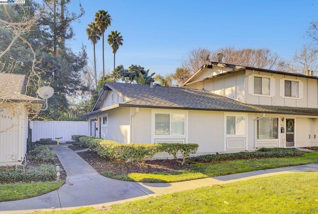 view of side of property with a yard