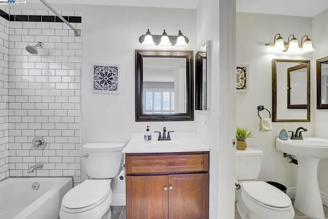 full bathroom featuring sink, tiled shower / bath combo, and toilet