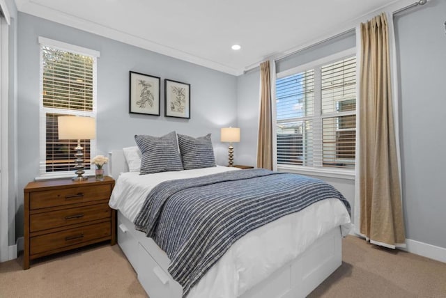 bedroom with ornamental molding and light carpet