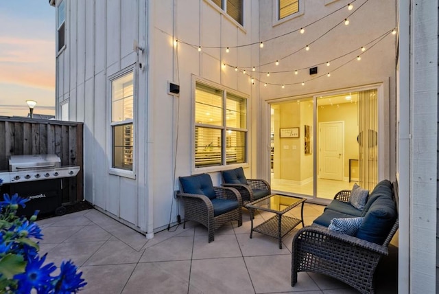 patio terrace at dusk featuring a grill and an outdoor hangout area