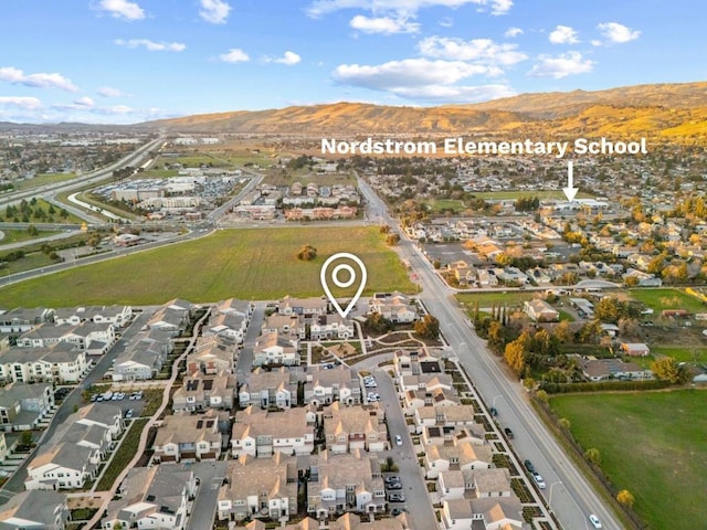 birds eye view of property with a mountain view