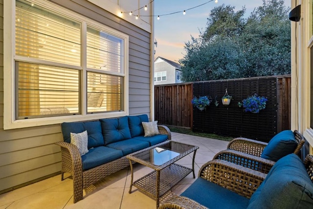 patio terrace at dusk featuring an outdoor hangout area