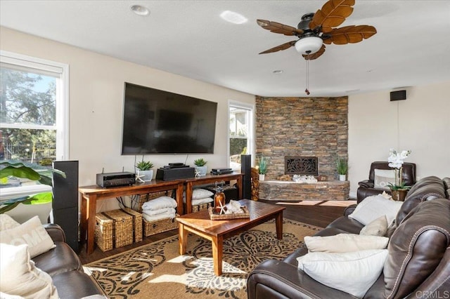 living room with hardwood / wood-style flooring, a fireplace, and ceiling fan