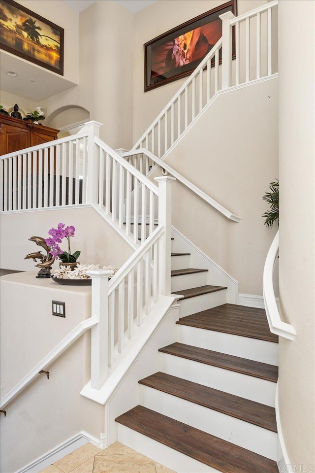 staircase featuring tile patterned floors